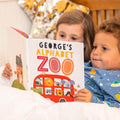 Children reading Zoo book