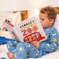 A child reading a personalized alphabet zoo story book