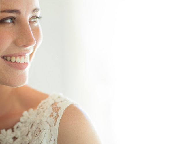 Bride smiling with her mother, both glowing with joy and emotion on the wedding day, capturing a candid moment of love, support, and celebration